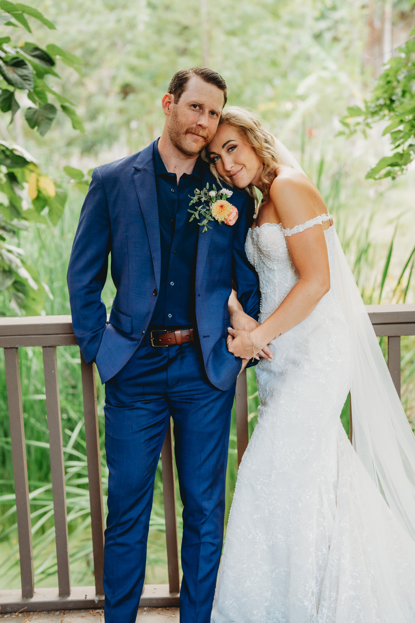 Bride and groom embracing on a balcony