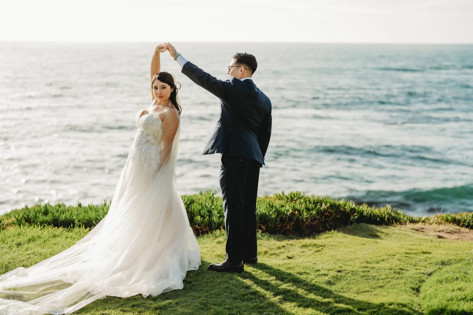 Couple dancing above the ocean at sunset