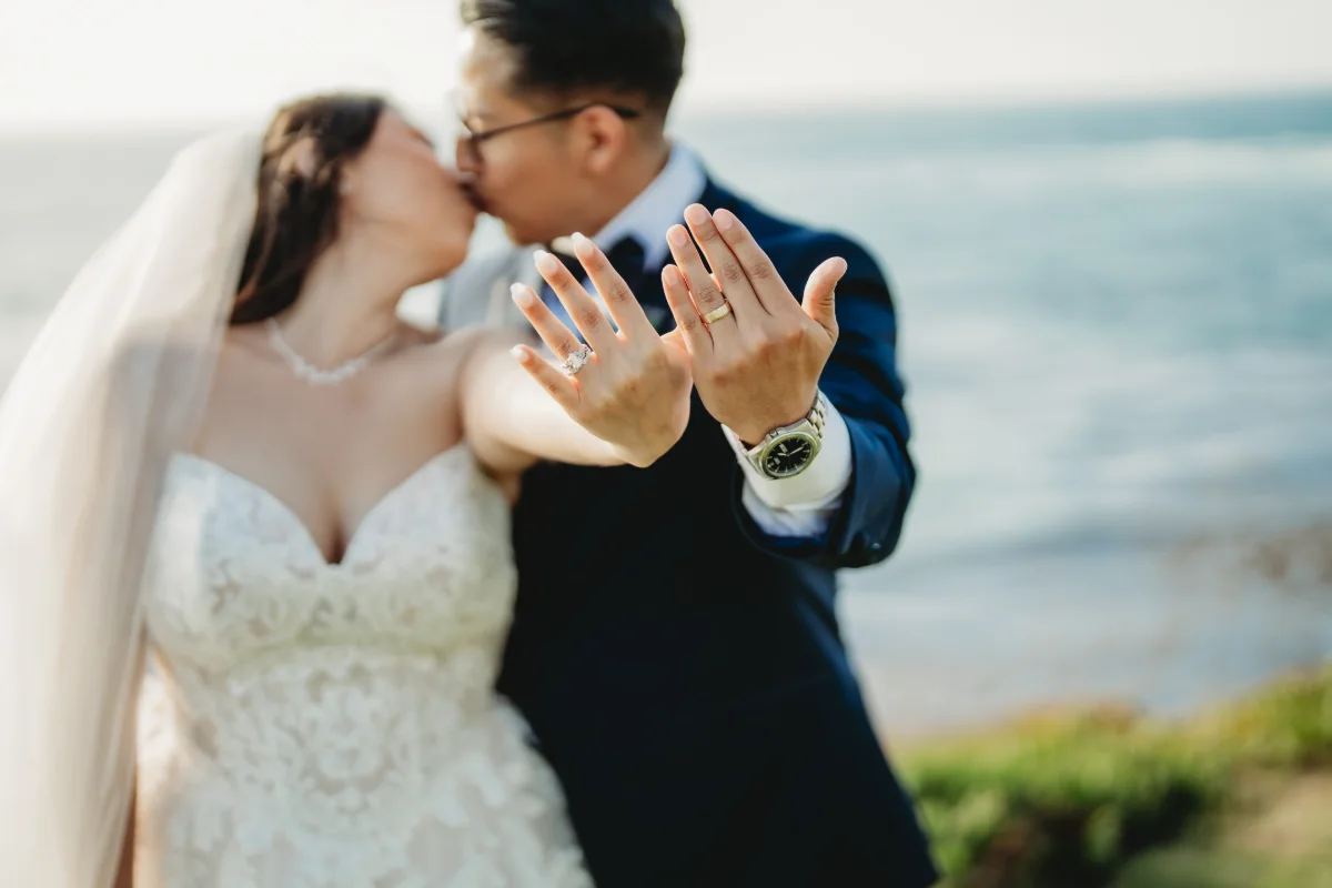 Couple kissing, rings shown
